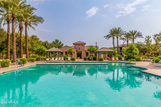 a view of swimming pool with a garden and lake view