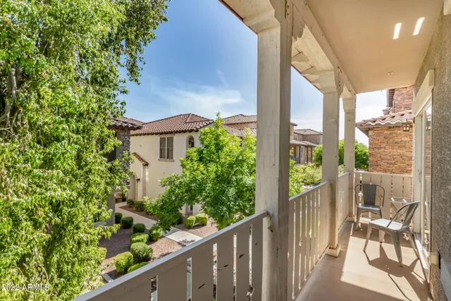 a view of a balcony with potted plants