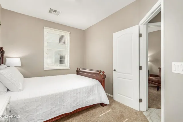 a bedroom with a bed and a window