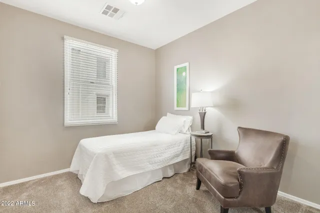 a bedroom with a bed and couch