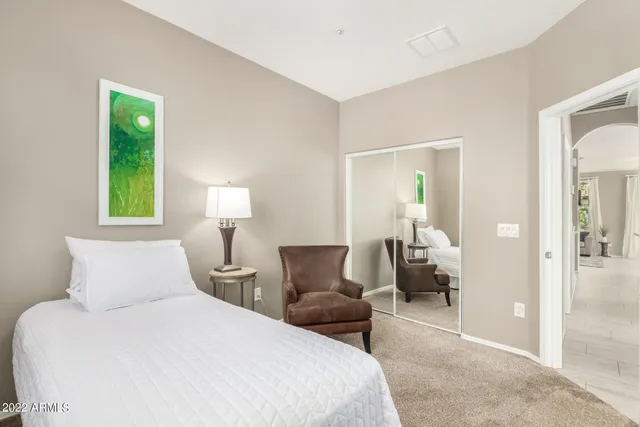 a bedroom with bed and window