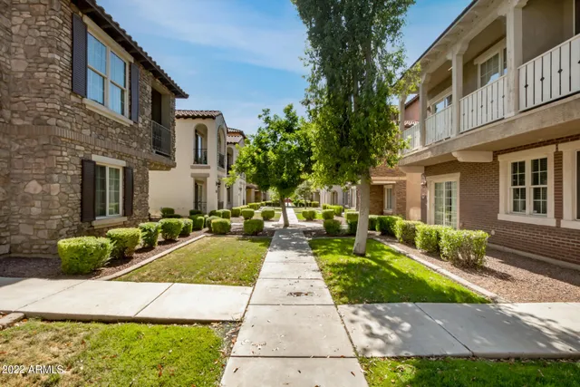 a view of a house with backyard sitting area and garden