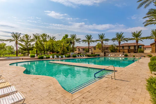 a view of swimming pool with outdoor seating and city view
