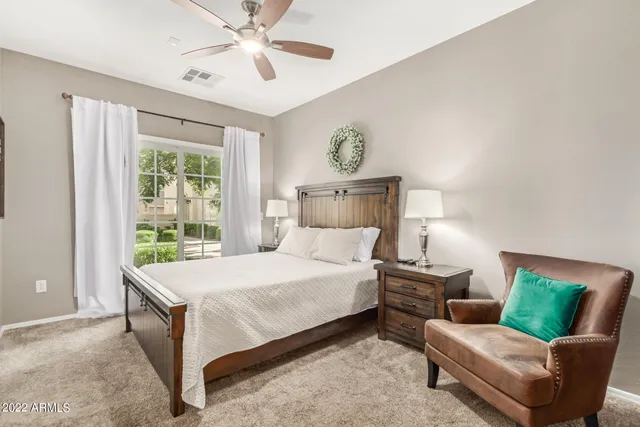 a bedroom with a bed couch and window