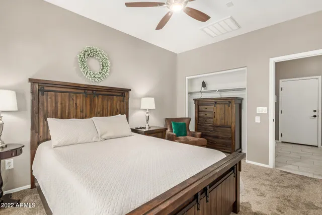 a bedroom with a large bed and a chandelier
