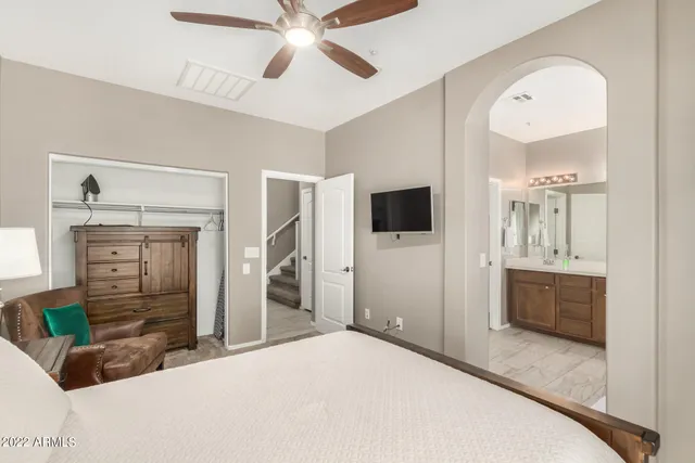 a bedroom with a bed and a flat tv screen