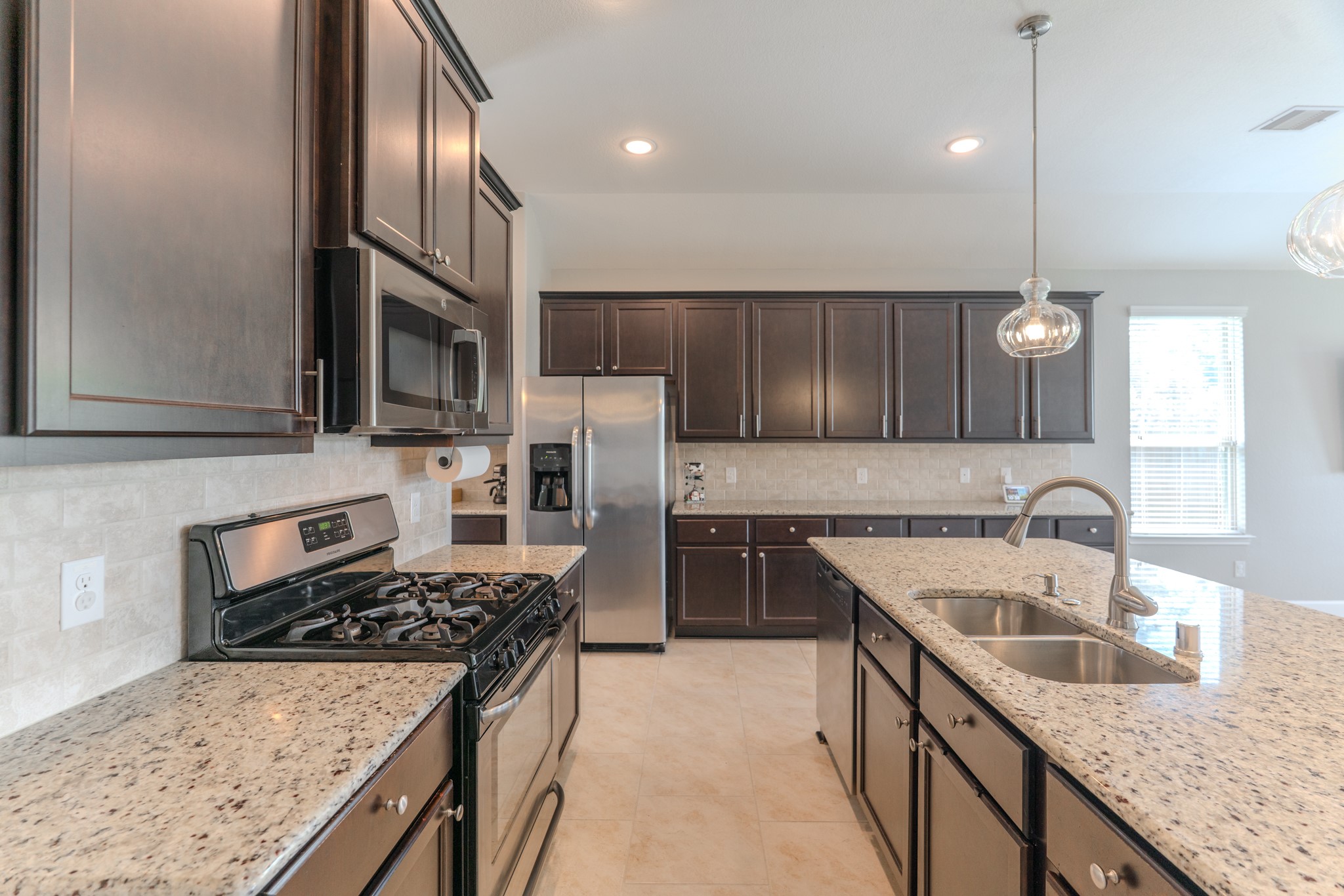 24322 North Newcastle Bay Trail Spring, TX 77389 - Photo 14 of 50 a kitchen with a stove sink and cabinets