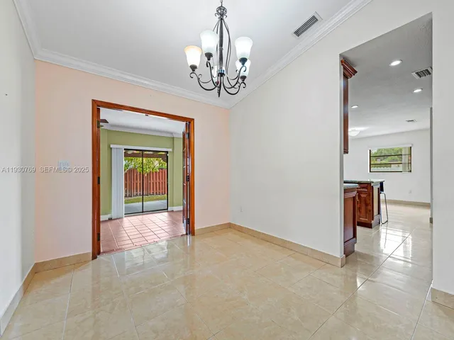 en view of an empty room with a chandelier