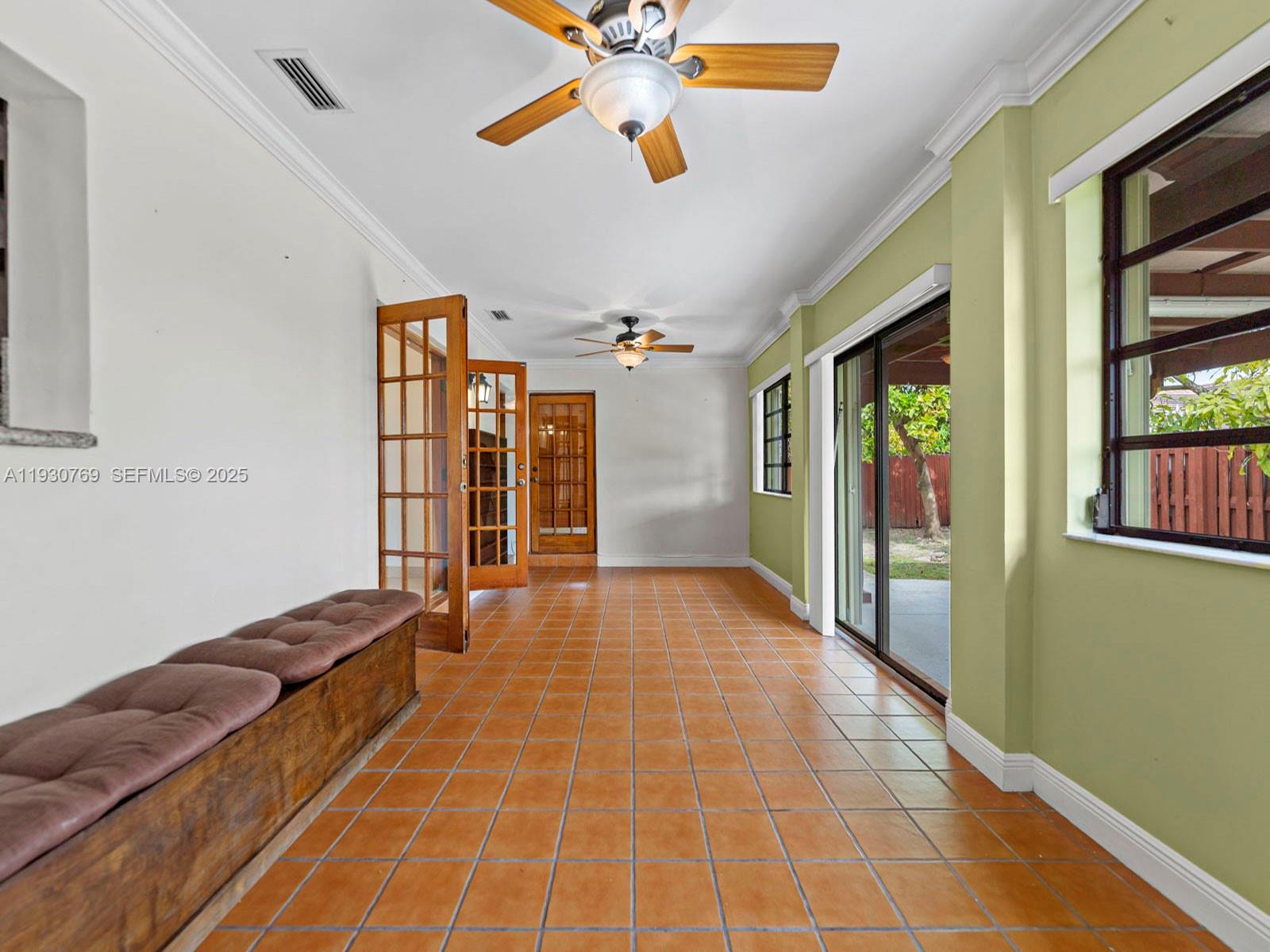 3791 Southwest 142nd Avenue Miami, FL 33175 - Photo 23 of 44 a hallway with a large window and a chandelier