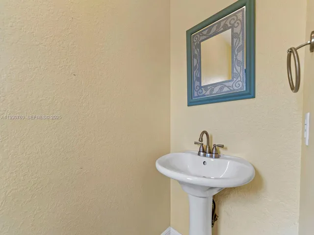 a bathroom with a sink and mirror