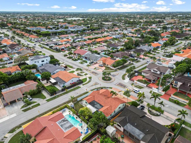 an aerial view of residential houses with outdoor space
