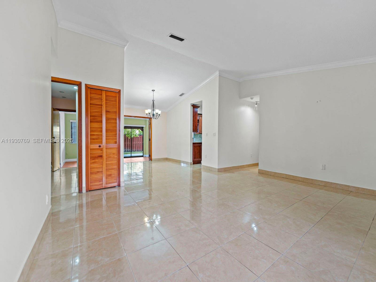 3791 Southwest 142nd Avenue Miami, FL 33175 - Photo 6 of 44 a view of an empty room with wooden floor and a window