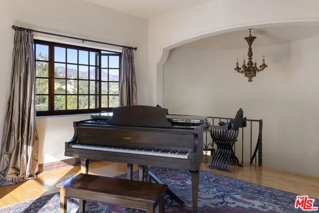 a living room with furniture and a piano