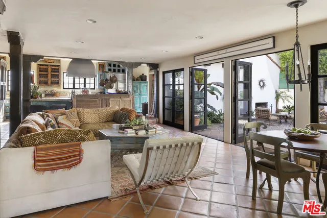 a living room with fireplace furniture and a large window