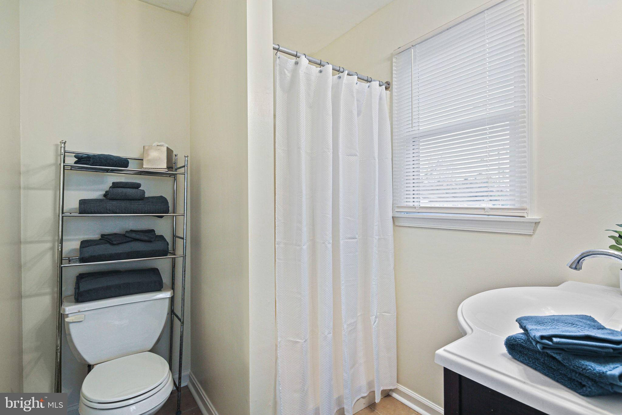1617 Midland Road Edgewater, MD 21037 - Photo 19 of 41 a bathroom with a toilet and a window