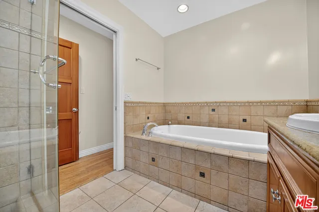 a spacious bathroom with a sink a mirror and a shower