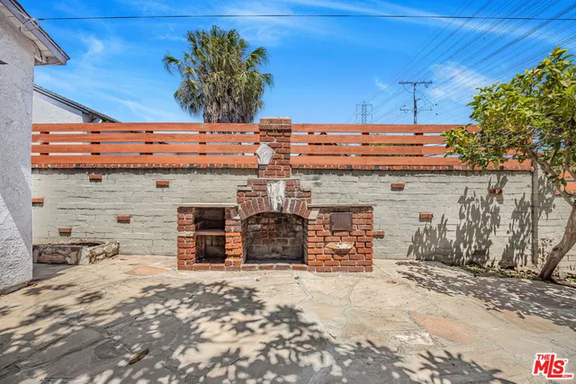 a view of a backyard with a chair and a fireplace