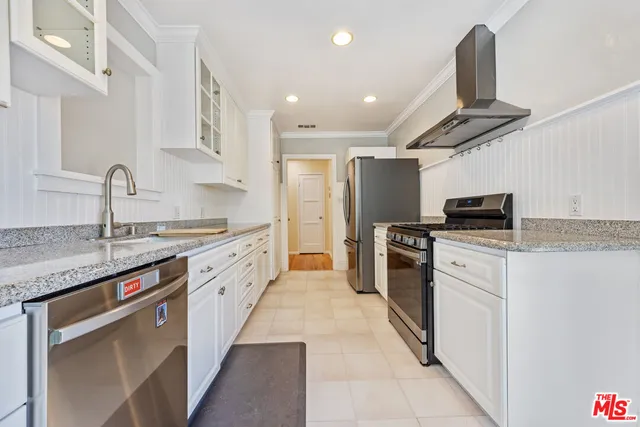 a kitchen with a sink cabinets and appliances