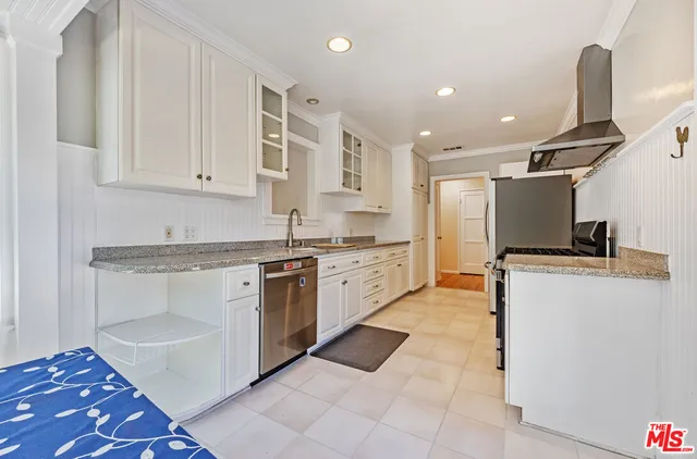 a stove top oven sitting inside of a kitchen