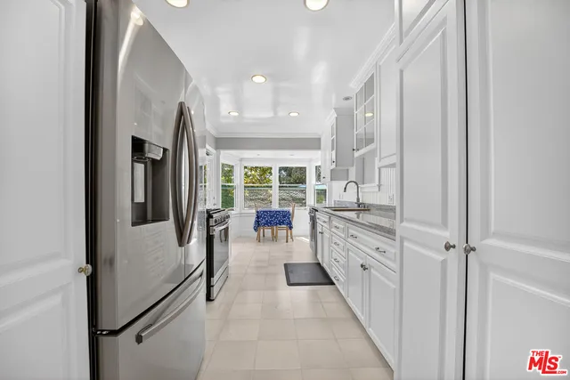a kitchen with refrigerator and cabinets