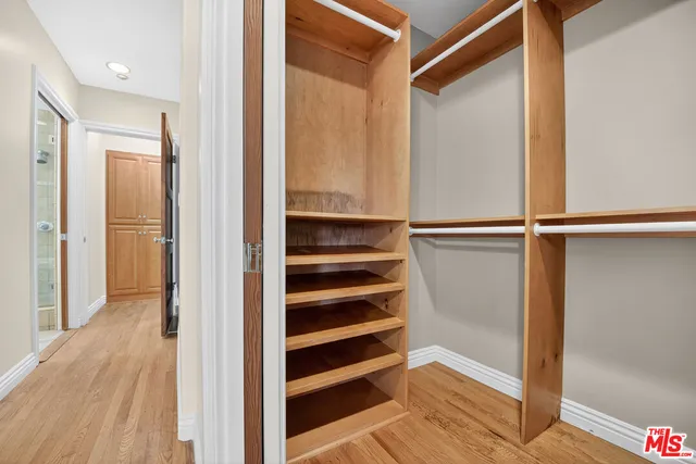 a view of walk in closet with empty racks
