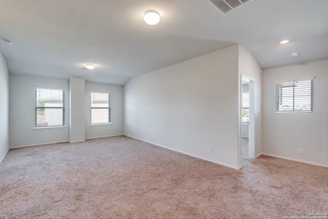 an empty room with windows and closet