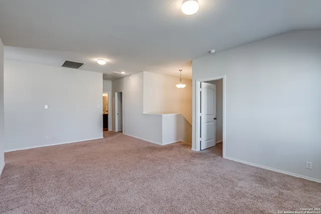 a view of a big room with a refrigerator