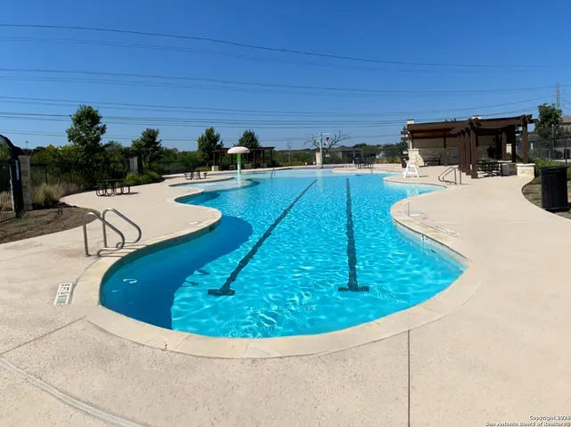 a view of a swimming pool with outdoor seating
