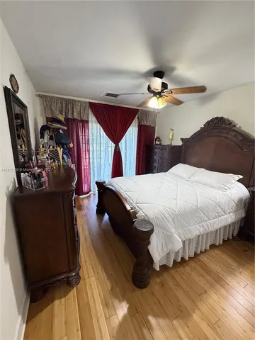 a spacious bedroom with a bed and a chandelier
