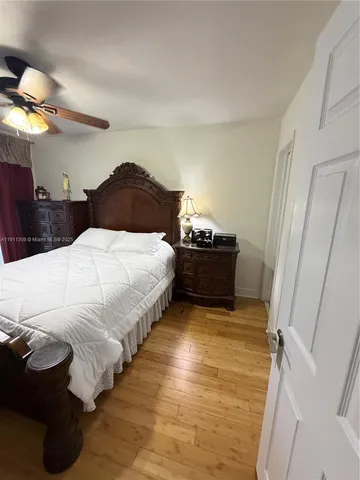 a spacious bedroom with a bed and a window