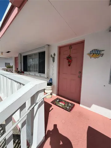 a view of a balcony with wooden floor