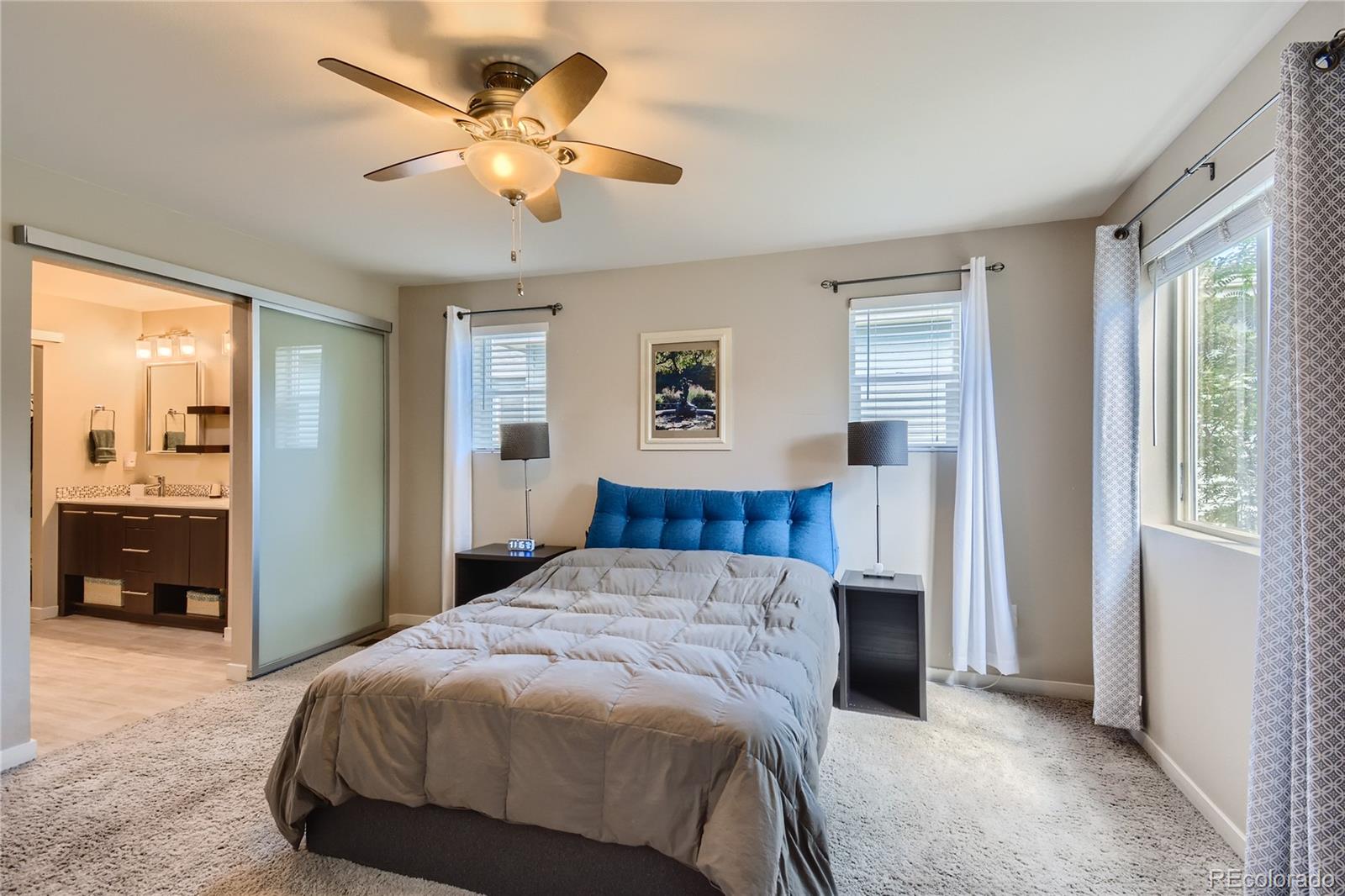 3319 Cranston Circle Highlands Ranch, CO 80126 - Photo 16 of 28 a bedroom with a bed and a chandelier