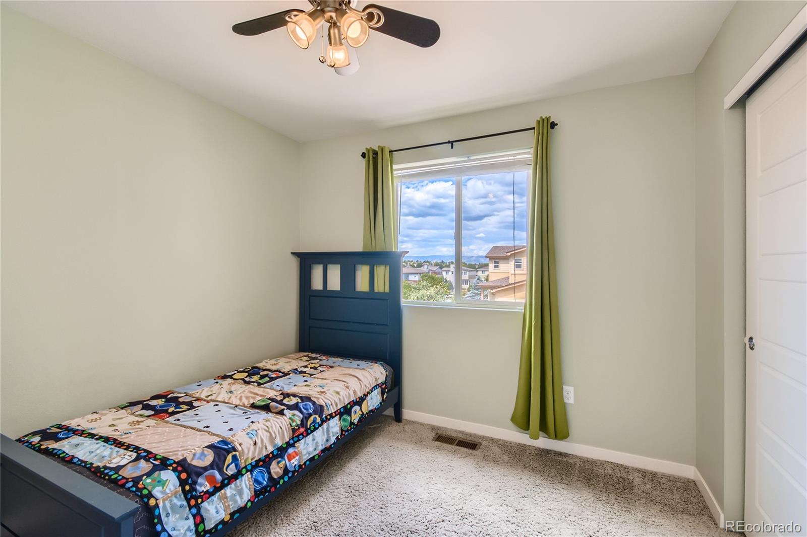 3319 Cranston Circle Highlands Ranch, CO 80126 - Photo 20 of 28 a bedroom with a bed and a window