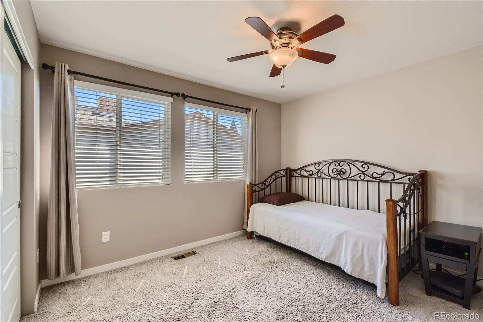 3319 Cranston Circle Highlands Ranch, CO 80126 - Photo 21 of 28 a bed sitting in a bedroom next to a window