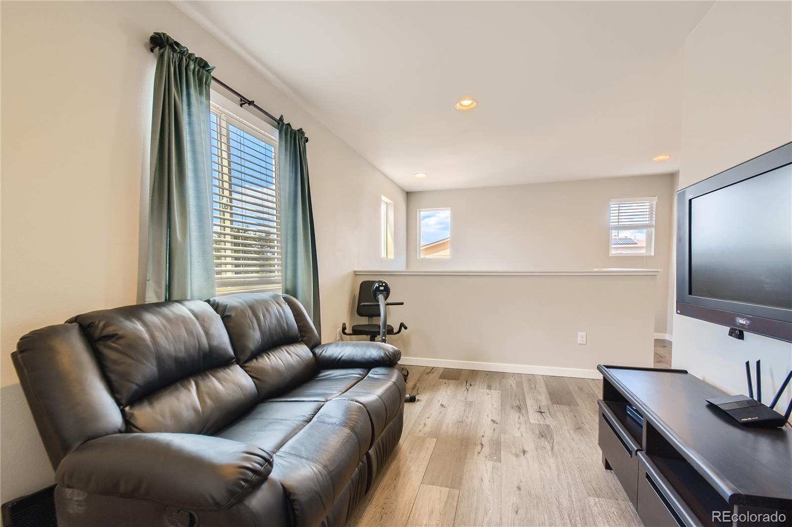 3319 Cranston Circle Highlands Ranch, CO 80126 - Photo 23 of 28 a living room with furniture and a flat screen tv