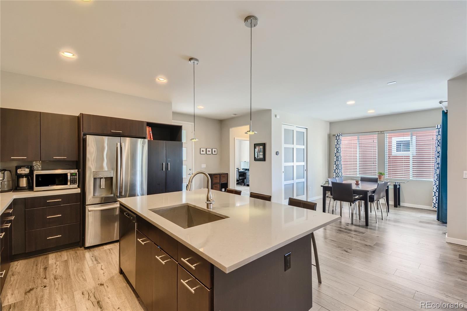 3319 Cranston Circle Highlands Ranch, CO 80126 - Photo 6 of 28 a kitchen with stainless steel appliances granite countertop a sink a stove and a refrigerator
