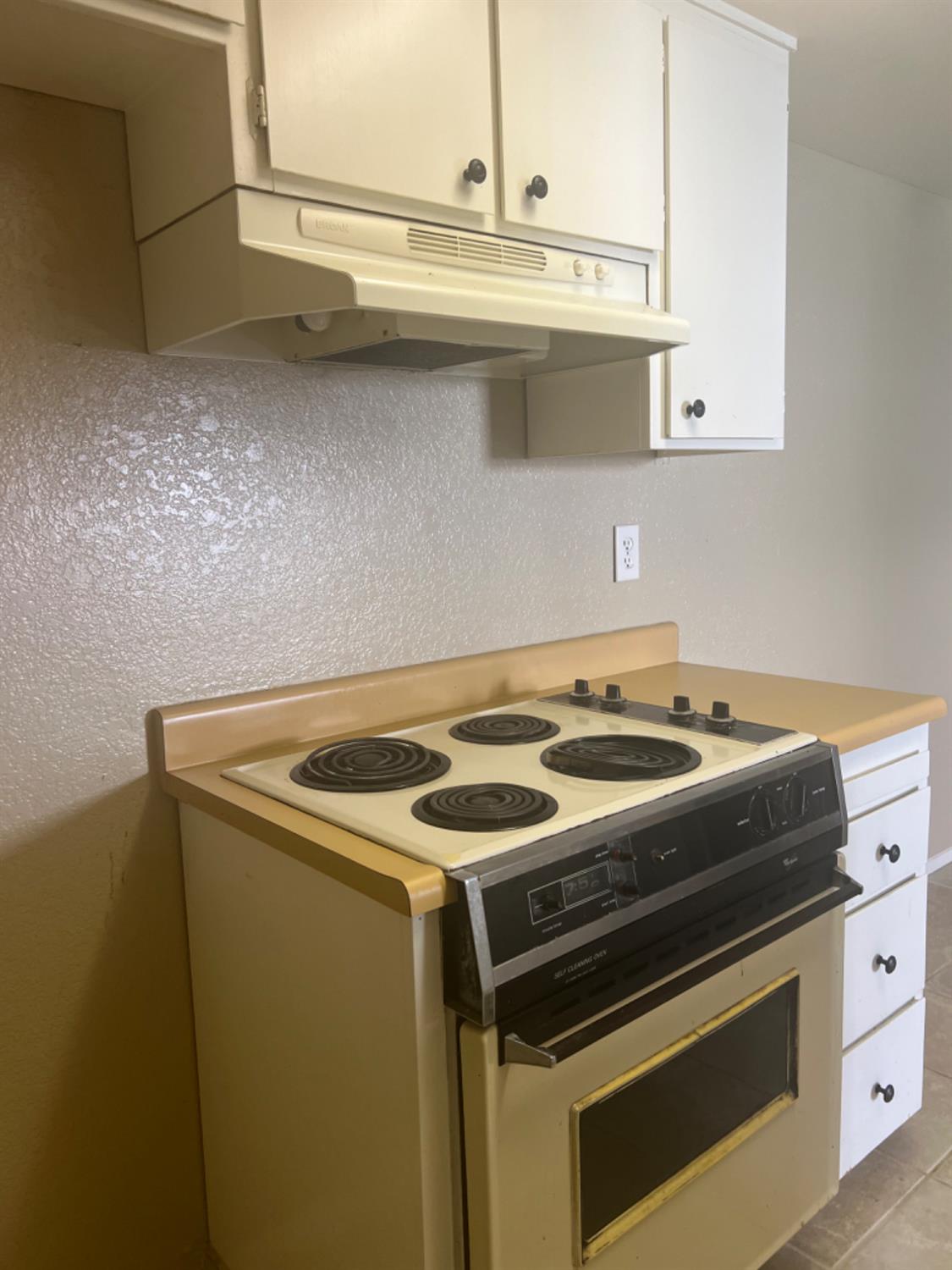 1545 Pyrenees Avenue, Unit 30 Stockton, CA 95210 - Photo 21 of 28 a white stove top oven sitting inside of a kitchen
