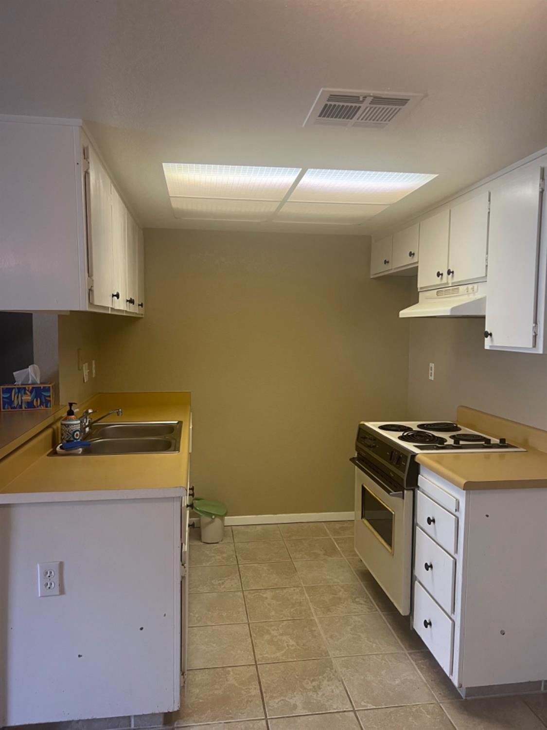 1545 Pyrenees Avenue, Unit 30 Stockton, CA 95210 - Photo 7 of 28 a kitchen with a stove and a sink