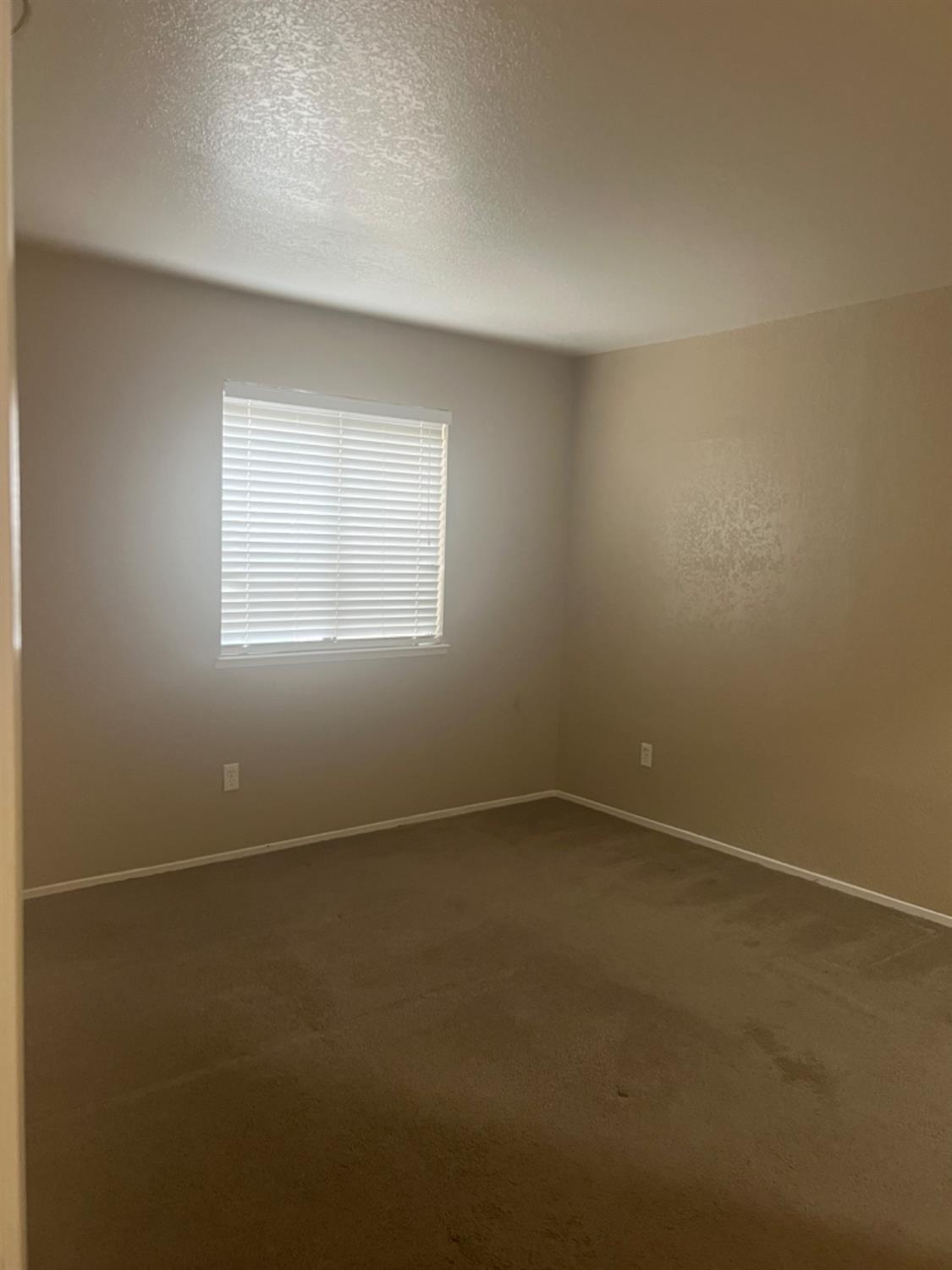 1545 Pyrenees Avenue, Unit 30 Stockton, CA 95210 - Photo 8 of 28 an empty room with a window