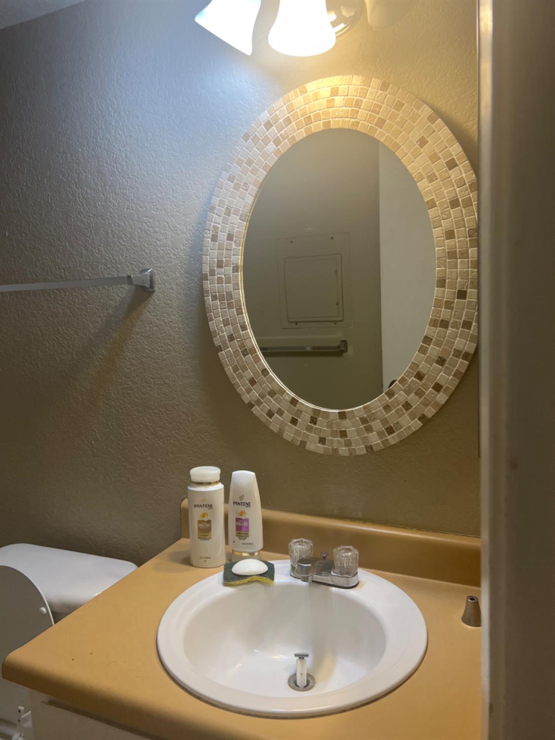 1545 Pyrenees Avenue, Unit 30 Stockton, CA 95210 - Photo 9 of 28 a bathroom with a sink and a mirror