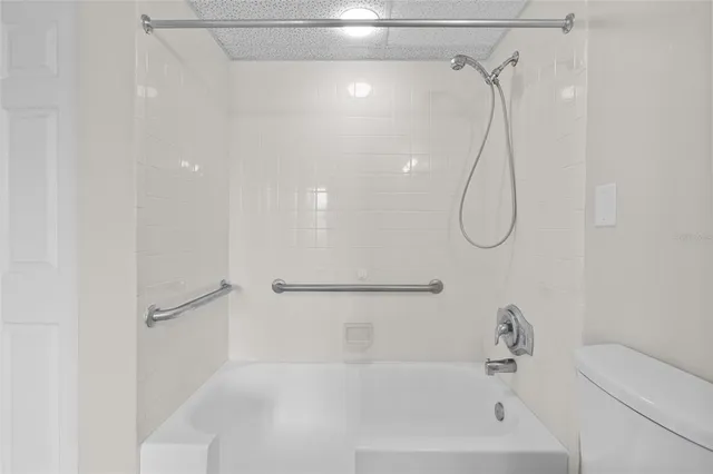a bathroom that has a bath tub with a shower