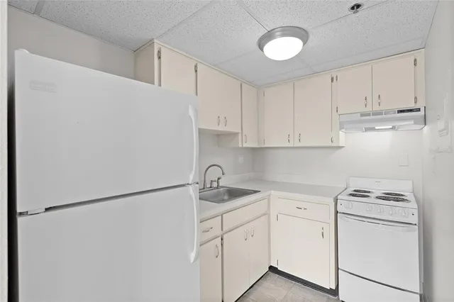 a kitchen with appliances cabinets and a sink