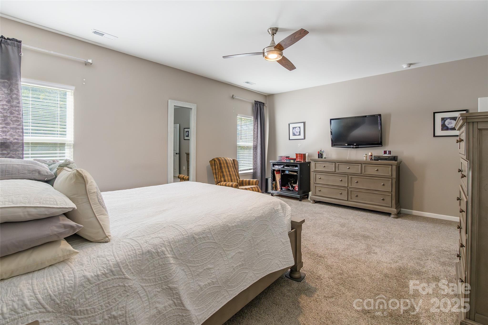 200 Clauser Road South Mount Holly, NC 28120 - Photo 22 of 44 a spacious bedroom with a bed and a flat screen tv