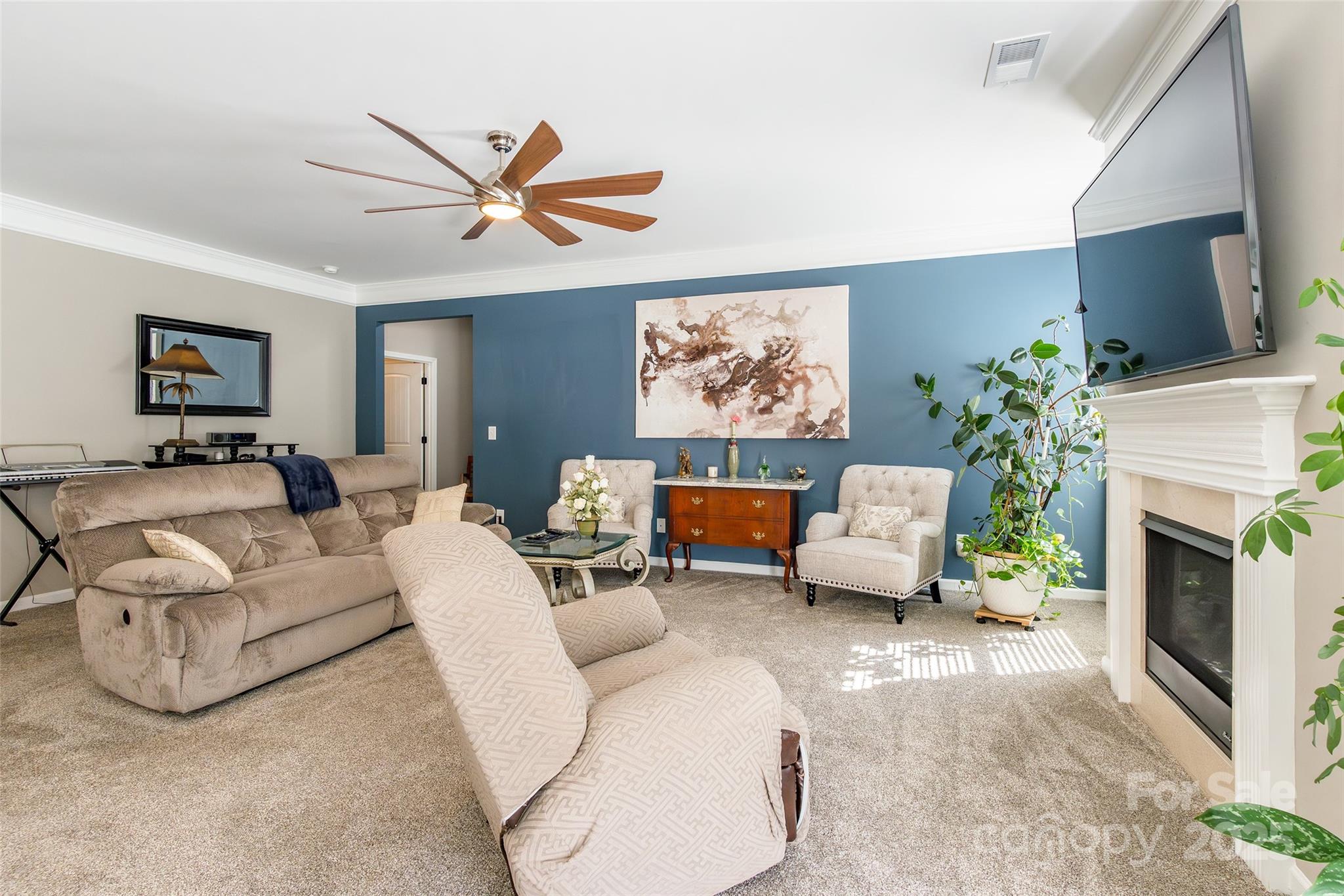 200 Clauser Road South Mount Holly, NC 28120 - Photo 8 of 44 a living room with furniture a fireplace and a flat screen tv