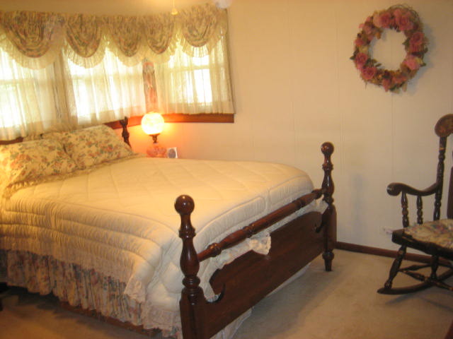 224 East Harrison Road Lombard, IL 60148 - Photo 7 of 24 a bed sitting in a bedroom next to a window