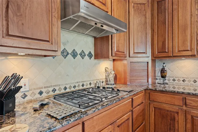 a kitchen with granite countertop a stove and a sink