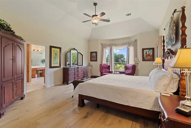 a bed room with a bed window and a chair