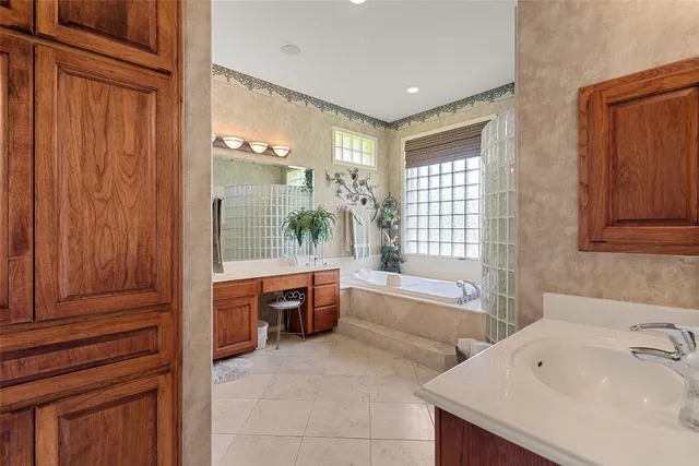 a bathroom with a tub sink and mirror