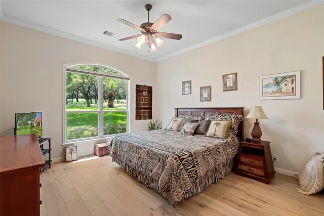 a bedroom with a large bed and a window