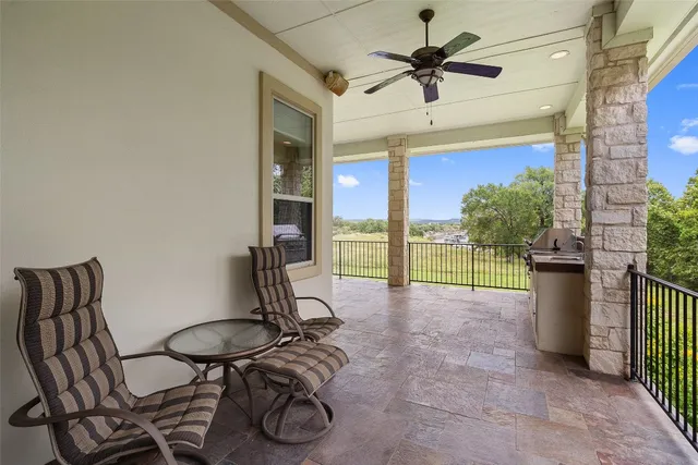 a view of a livingroom with furniture and a floor to ceiling window